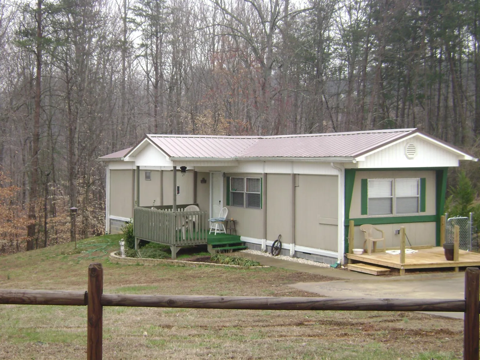 Mauve metal roof on a manufactured home with a new front deck in Upper Falls